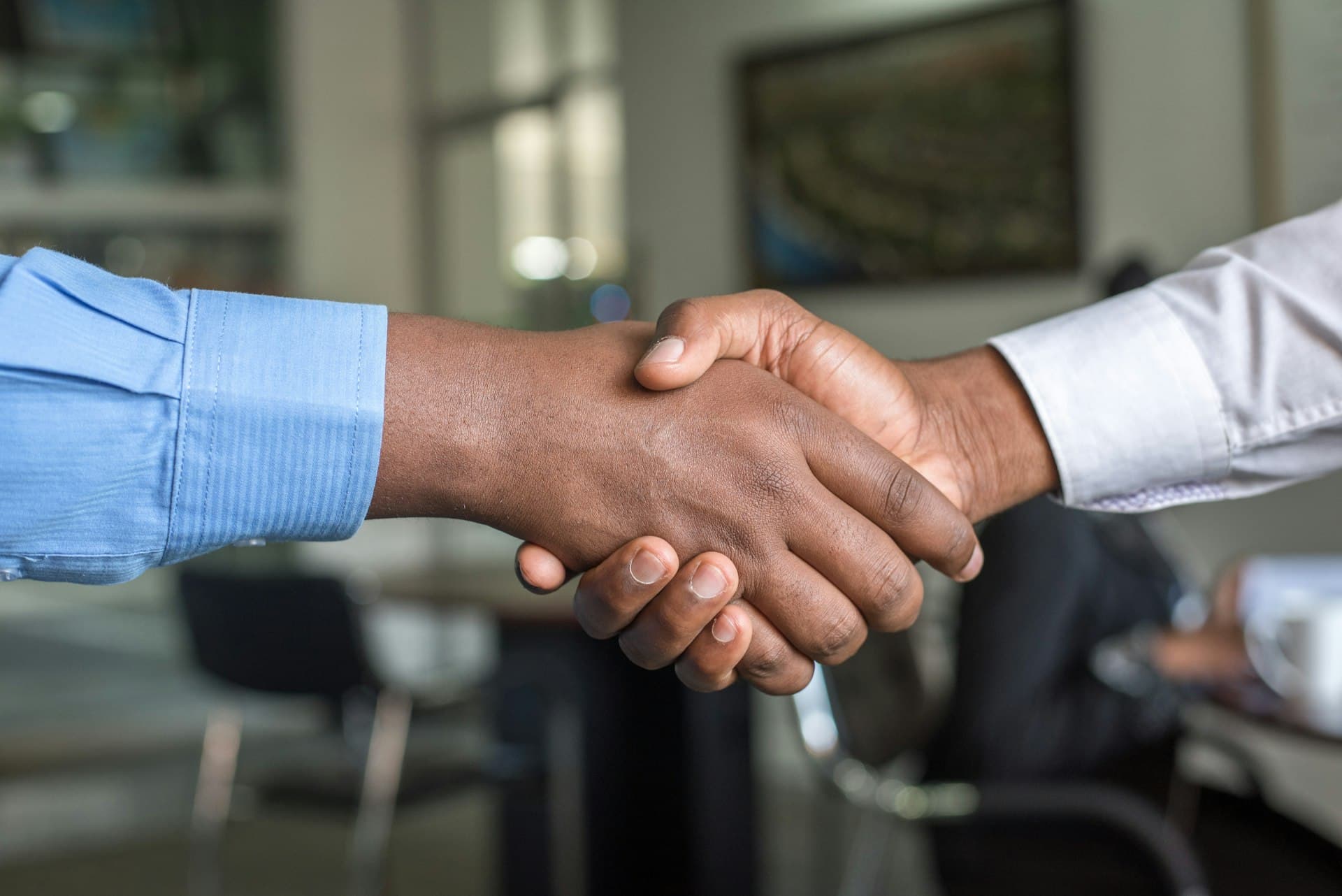Two businesspeople closing a deal with a handshake